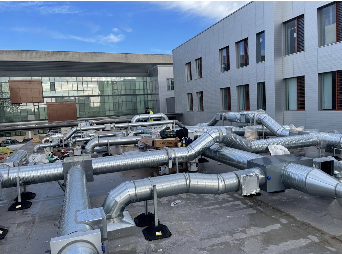 Rooftop industrial spiral ductwork on a UK manufacturing facility serviced by Deduct Ltd